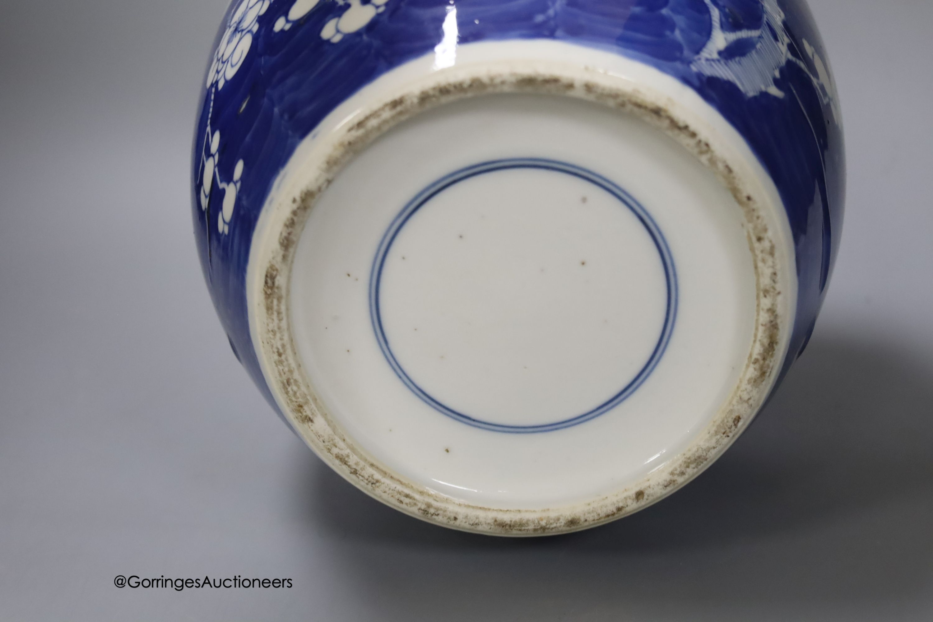 A 19th century Chinese porcelain prunus jar and cover, 27cm, on carved wood stand, a smaller famille noire jar and cover, a Chinese export fruit bowl, blue and white dish and a similar jar and cover 27cm